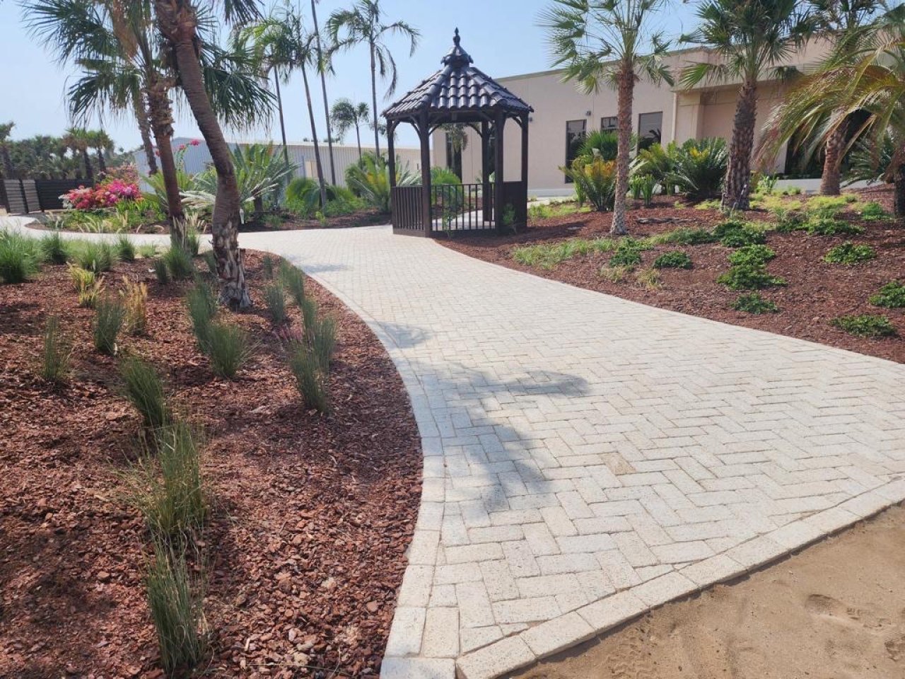 Partanna pavers leading to a pergola in a garden.